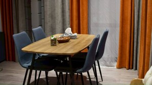 A dining table with chairs, a bowl, and a glass with a drink. - MATRYOSHKA HOUSE (Yoichigun)