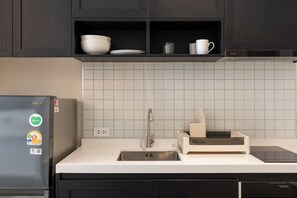 A kitchen with a refrigerator, a sink, and a countertop with a toaster. - Utopia Dream Apart-Hotel Nai Harn (Rawai)