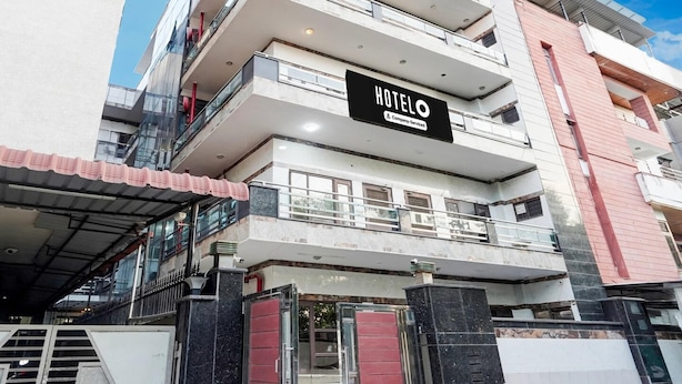 A multi-story hotel building with a prominent 'HOTEL' sign, large windows, and a modern architectural design.