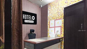 A reception desk with a sign indicating it's a company-serviced hotel.