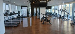 A gym with treadmills, stationary bikes, and weight machines.