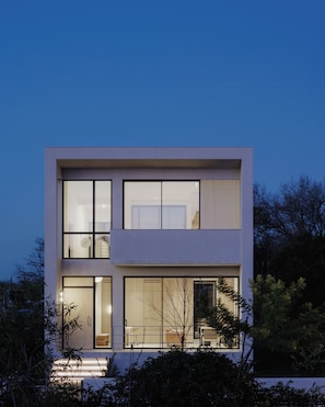 A modern two-story building with large windows, a flat roof, and a minimalist design. - The Habitus Project (Kerkira)