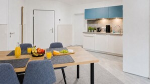 A modern kitchen with white cabinets, a blue countertop, and a coffee maker. - MEERholung House, Vacation Rental 2.5 - About 400 m from the beach, for up to 4 guests - House (Cuxhaven)