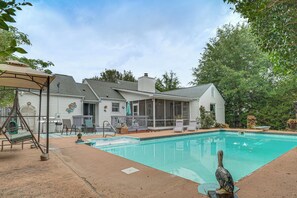 A backyard with a swimming pool, patio furniture, and a covered seating area. - Screened Porch, Private Pool! Family Home in Aiken (Aiken)