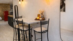 A dining area with a table, chairs, wall-mounted lights, and a mirror. - Art Loft # Design - Near Croisette | Beaches - A/C (Cannes)