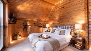 Un dormitorio con paneles de madera, una cama grande, lámparas de noche y un televisor montado.