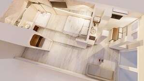 Una camera d'albergo moderna con un letto, un piccolo angolo salotto, una toeletta e una finestra.
