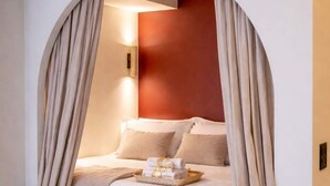 A bedroom with a bed, curtains, and a wall-mounted light. - Architect Suite # Chic Design - Croisette - Beach (Cannes)