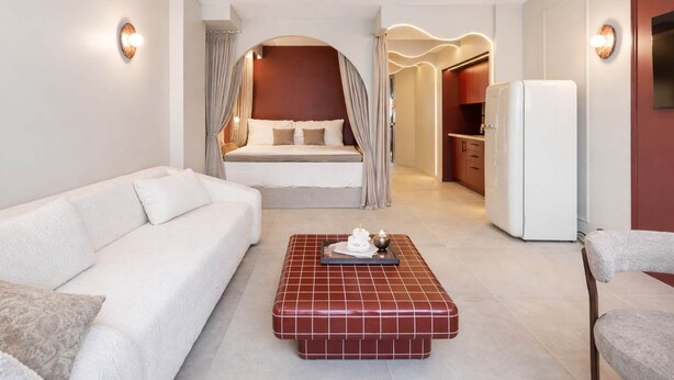 A hotel room with a bed, a sofa, a coffee table, and a kitchenette. - Architect Suite # Chic Design - Croisette - Beach (Cannes)