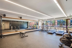 A gym with treadmills, elliptical machines, and weight equipment. - Realm (Menlo Park)