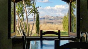 A dining table with chairs, a view of a rural landscape with trees and mountains through large windows. - Amazing home in Manciano with private swimming pool, can be inside or outside (Manciano)