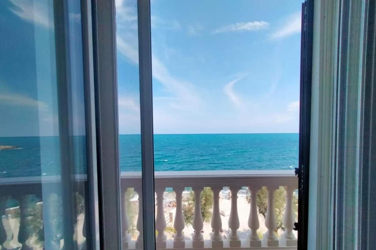 A balcony with a view of the sea.