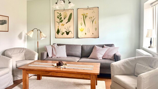 A living room with a sofa, two armchairs, a coffee table, and botanical wall art. - 2 bedroom lovely home in Sjöbo (Sjöbo)