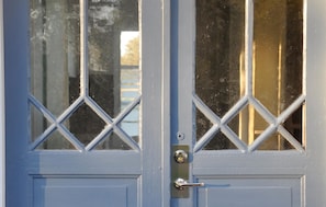 A blue door with diamond-patterned glass panes and a metal handle. - 1 bedroom gorgeous home in Köpingsvik (Köpingsvik)