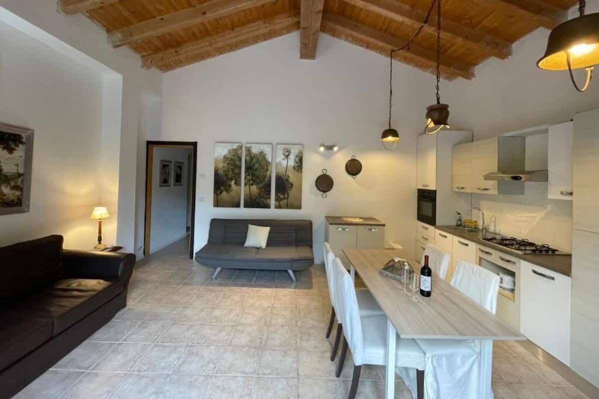 Un interior moderno con techo de madera, comedor, cocina y sala de estar.