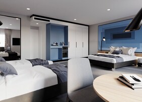 Una habitación de hotel moderna con dos camas, un escritorio, una mesa redonda y un espejo grande.