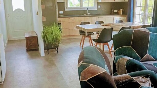 A modern living room with a sofa and a dining area with a table and chairs. - Charming house with swimming pool in the heart of Périgord Noir (LE BUGUE 24260) (Le Bugue)