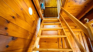 A wooden staircase with a handrail, wooden walls, and a ceiling with a circular light fixture. - Guest Room - Chalet in Pays d'Auge with Garden (Lessard-et-le-Chêne)