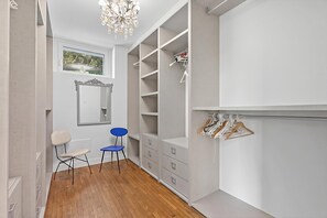 A walk-in closet with open shelving, a mirror, and a chandelier. - Villa Alessia - 4 bed Villa With Lake Maggiore View (Stresa)