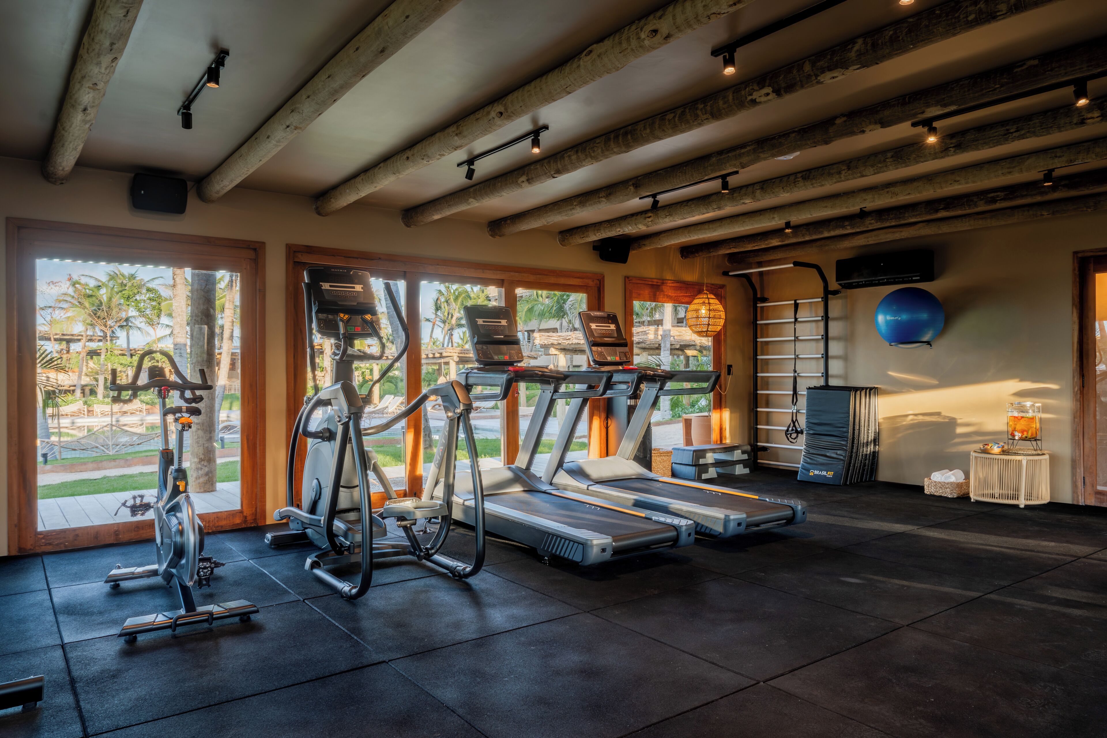 A gym with treadmills, stationary bikes, and elliptical machines.
