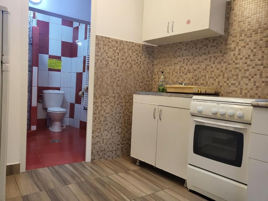 A kitchen with a stove, oven, and cabinets.