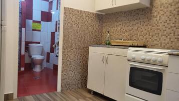 A kitchen with a stove, oven, and cabinets.