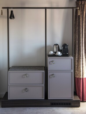 A compact, two-drawer metal cabinet with a textured top, placed on a dark wooden platform. - Palazzo De Polo (Venice)