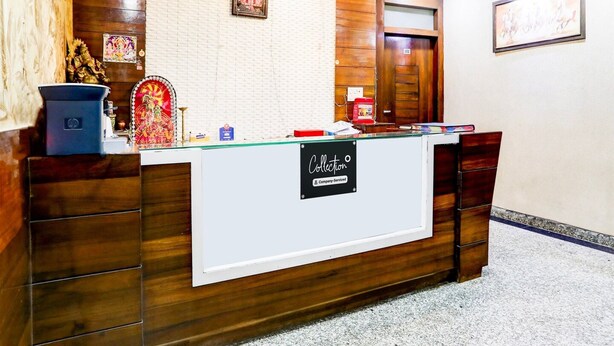 A reception desk with a sign reading 'Collection,' a wooden panel wall, a framed picture, and a door with the number '101.'