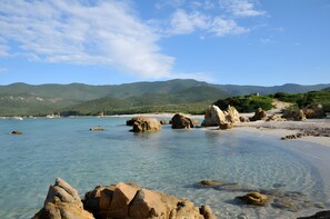 A coastal landscape with clear waters, rocky formations, and distant mountains. - Spacious Villa with Exceptional Sea View (Serra-di-Ferro)