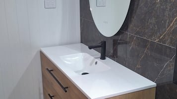 Shower, hair dryer, towels, toilet paper