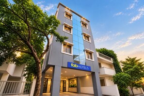 A multi-story hotel with a modern facade, a prominent sign for 'fabHOTELS', and a well-lit entrance. - FabHotel Galaxy Apartment (Pune)