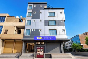 A modern hotel building with multiple floors, a prominent entrance, and a sign for 'fabHOTELS HOTEL DEEP'. - Fabhotel Deep (Jaipur)