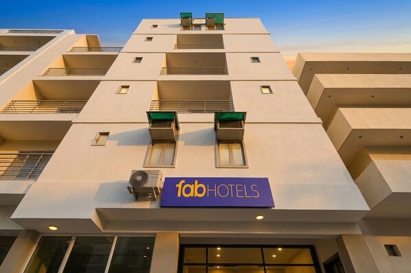 A modern building with a flat facade, multiple balconies, and a sign for 'fabHOTELS'. - FabHotel Legend Stay - Dwarka Sector 7 (New Delhi)