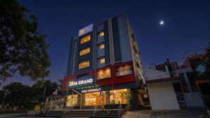 A multi-story building with a 'JAYA GRAND' sign and a 'FAMILY RESTAURANT' sign. - FabHotel Jaya Grand - Nr. Railway Station (Guntur)