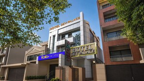 A modern hotel building with a sign reading 'HOTEL DEV PALACE' and a smaller sign for 'fabHOTEL.' - FabHotel Dev Palace II - Nr Ashok Vihar (New Delhi)