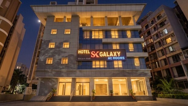 A multi-story hotel with a prominent sign for 'Hotel Galaxy AC Rooms.' - Fabhotel Sk Galaxy (Thane)