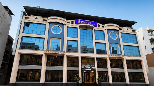 A multi-story hotel with a prominent 'fabHOTELS' sign, large windows, and a 'The City Park Hotel' entrance. - FabHotel Prime The City Park (Hyderabad)