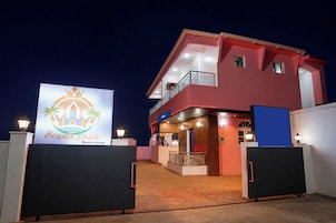 A two-story building with a sign for 'Royal Castle Beach Home.'