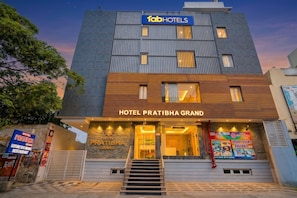 A modern hotel building with a sign for 'Hotel Pratibha Grand' and 'Tab Hotels.' - Fabhotel Pratibha Grand (Vijayawada)