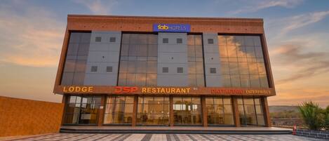 A building with a 'fab hotels' sign, 'Lodge', 'DSP Restaurant', and 'Datataguru Enterprises' signage.