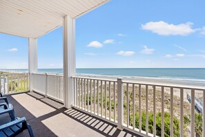 A covered balcony with a view of the beach and ocean. - Atlantis Villas #201 | Oceanfront 6 Bedroom Condo 5 Bath (North Myrtle Beach)