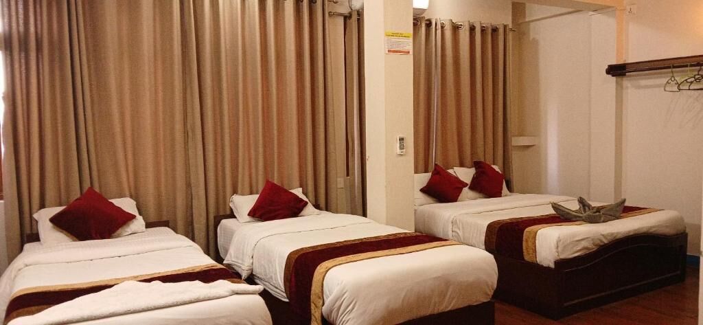 Economy Triple Room, Garden View | Blackout drapes, iron/ironing board, free WiFi