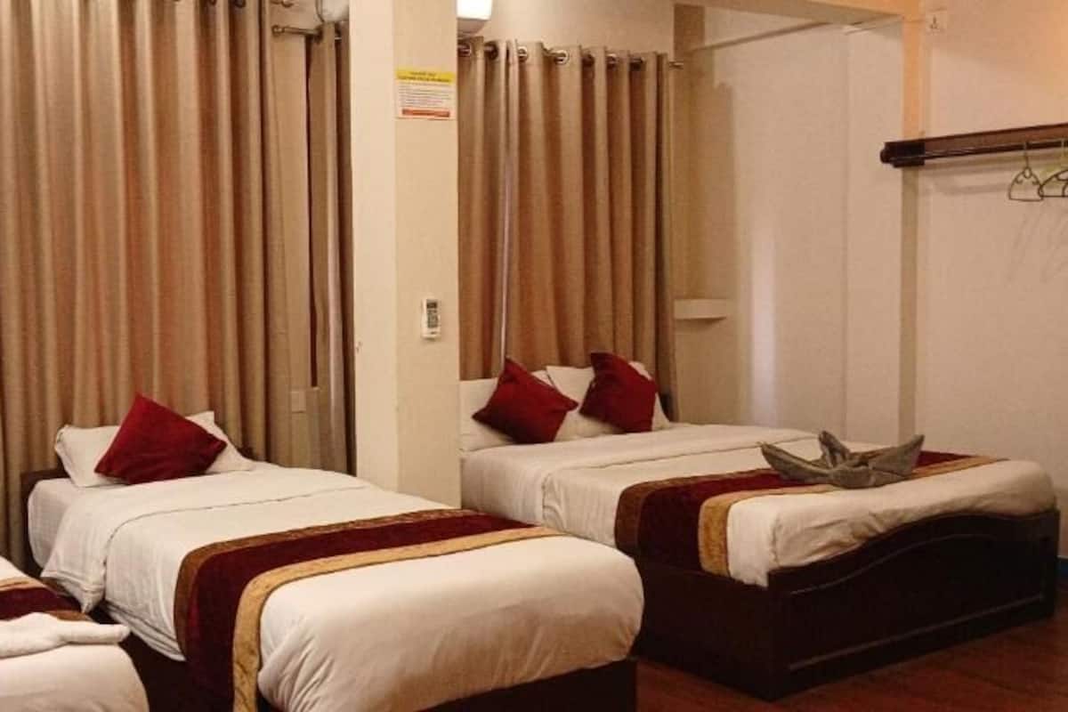 Economy Triple Room, Garden View | Blackout drapes, iron/ironing board, free WiFi