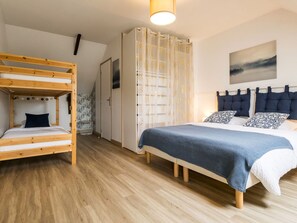 A room with a bunk bed, a single bed, a wardrobe, and a painting on the wall. - Gîte with pool and wifi - 8 guests (Le Pin)