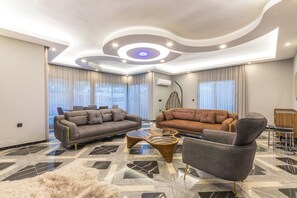 A modern living room with two sofas, a coffee table, and a fluffy rug. - Daisy Villa Icmeler Marmaris Private (Marmaris)