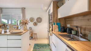 A modern kitchen with a wooden countertop, stainless steel sink, and a built-in oven. - Villa with Pool Just 500 Meters from the Beach (Begur)