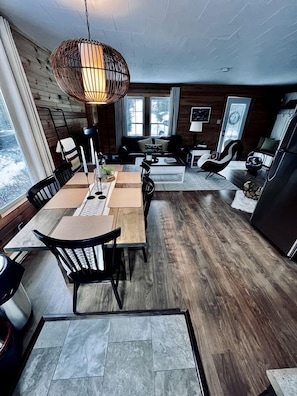 A modern interior with a dining area, kitchen, and seating space.