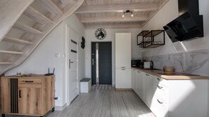 A kitchen with wooden cabinets, a countertop, and a built-in stove.