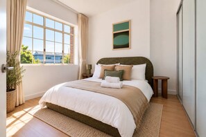 Comfortable and peaceful bedroom featuring a plush queen bed, built-in wardrobe storage, air conditioning, and soft natural light. Designed to provide a relaxing retreat after a day exploring Bondi and Sydney's eastern beaches. - Two-Bedroom Flat with Parking Near Bondi Beach (Bondi)