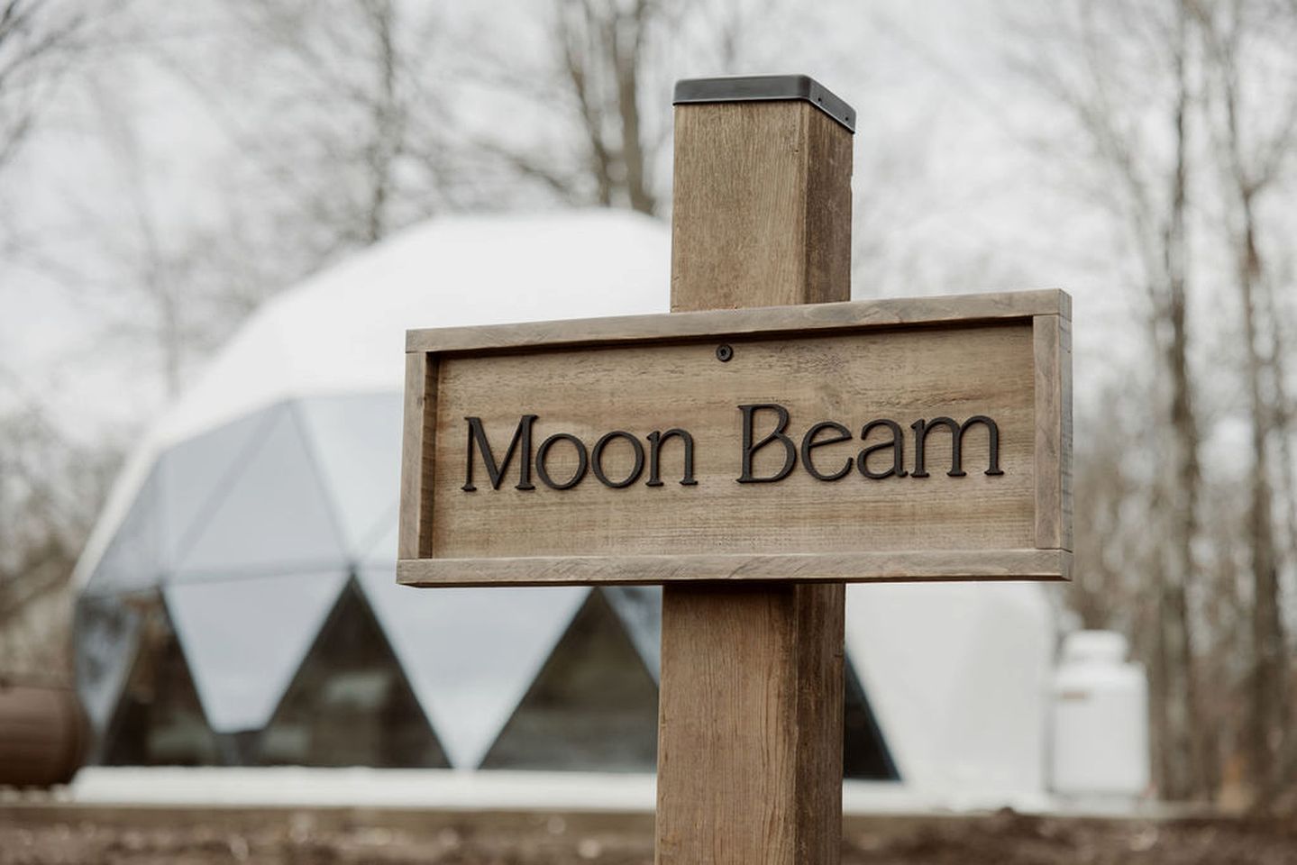 A wooden sign with 'Moon Beam' written on it.
